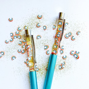 After the Storm Rainbow and Gold Glitter Pen -- Black, Ballpoint Pen with Blue Barrel