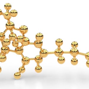 May include: A gold 3D model of a chemical compound, resembling a molecule, with multiple connected spheres.