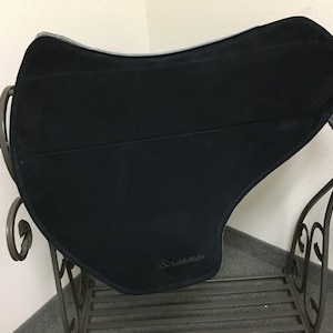 May include: Black saddle pad with a gray border and the text "SaddleRight" in white.