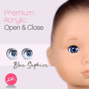 Peut inclure: Une paire d'yeux de poupée en acrylique saphir bleu avec un iris blanc et une pupille noire. Les yeux s'ouvrent et se ferment. Le texte "Premium Acrylic Open & Close" et "Blue Sapphire" est visible sur l'image.
