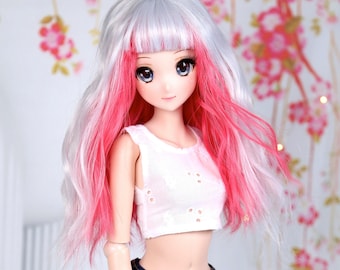 May include: A doll with long, wavy, white and pink hair, wearing a white crop top and denim shorts.