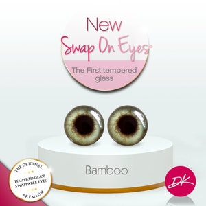 May include: A pair of green glass eyes with brown irises, labeled "Bamboo" and "New Swap On Eyes - The First Tempered Glass".