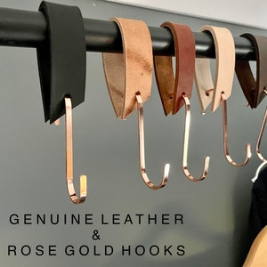 May include: A row of leather and rose gold hooks. The leather straps come in black, tan, brown, cream, and dark brown. The hooks are a shiny rose gold color. The text "GENUINE LEATHER & ROSE GOLD HOOKS" is at the bottom of the image.