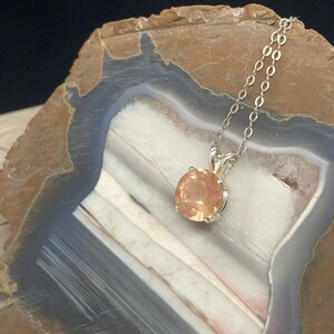 9mm 2.47ct round peach color, with schiller Oregon Sunstone pendant