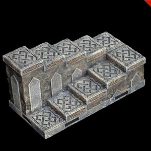 May include: A set of stone steps with intricate carvings and a weathered gray finish. The steps are decorated with a gold-colored trim.