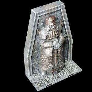 May include: A silver and bronze statue of a dwarf warrior holding a large axe. The statue is set in a stone alcove with a patterned base.