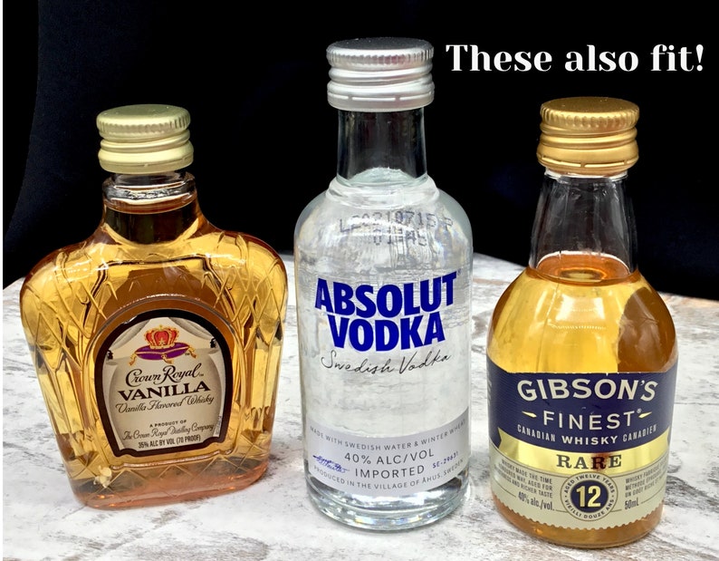 May include: Three miniature liquor bottles, two with gold caps and one with a silver cap. The bottles are labeled "Crown Royal Vanilla", "Absolut Vodka", and "Gibson's Finest Rare Canadian Whisky".