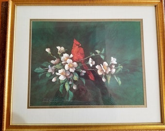 May include: Framed print of a red cardinal perched on a branch with white blossoms against a dark green background. The print is signed "Emily Rowan" in the bottom left corner.