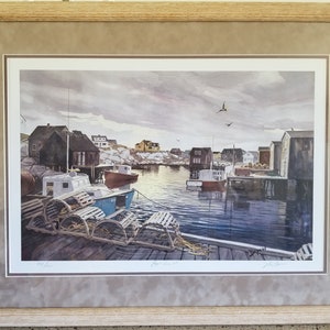 May include: A framed watercolor painting depicting a harbor scene with several boats docked at a pier. The boats are surrounded by colorful houses and a cloudy sky. The painting is signed by the artist, John Sloan.