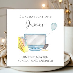 May include: Congratulations card featuring a watercolour illustration of a computer, a file folder, a phone, and a pencil. The card reads "Congratulations James on your new job as a software engineer".