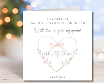 May include: A white engagement card with text that reads "TO A SPECIAL DAUGHTER & FUTURE SON IN LAW". The card features a heart-shaped floral design with a pink bow and the names "Haley and Elliot". The date "24.08.2024" is also included.