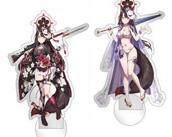 May include: Two acrylic standees featuring anime-style characters with fox ears and tails. The left figure wears a black and red floral outfit with a rifle, while the right figure wears a white bikini and purple robe with an umbrella. RoriWorks text.