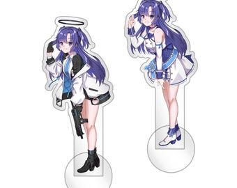 May include: Two acrylic standees featuring an anime-style character with long purple hair and a halo. One figure wears a white jacket and holds a black firearm, while the other wears a white and blue dress. The text RoriWorks is visible.