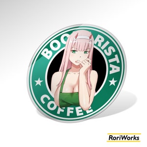 May include: A round, green and white sticker with the words "BOO RISTA COFFEE" encircling an anime-style illustration of a woman with pink hair and green eyes. She wears a green apron and is touching her lip with her finger.