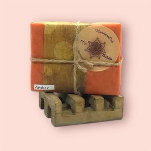 May include: A handmade, wooden cutting board with a natural finish. The rectangular board features a juice groove and a handle. Dimensions are approximately 18 inches long, 12 inches wide, and 1 inch thick.