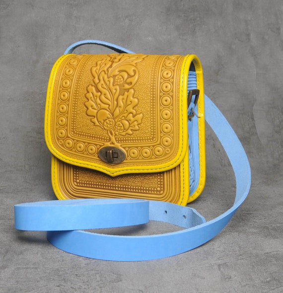Premium AI Image | A close up of a yellow purse on a blue surface  generative ai