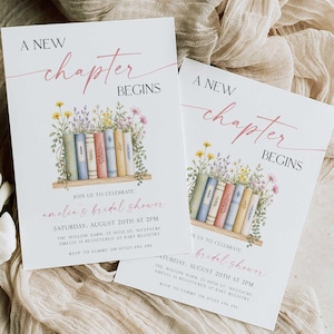 May include: Two white invitation cards with the text "A New Chapter Begins" in pink and black. The cards feature a watercolor illustration of books and flowers. The text "amelia's bridal shower" is also included.