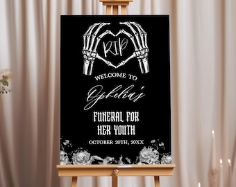 May include: Black and white welcome sign with a skeleton hand heart design. The sign reads "Welcome to Ophelia's Funeral for Her Youth, October 20th, 20XX".