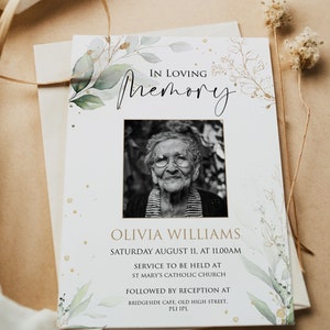 May include: A white memorial card with a green and gold floral design. The card features a black and white photo of an older woman and the text "In Loving Memory Olivia Williams Saturday August 11, at 11:00 AM Service to be held at St. Mary's Catholic Church Followed by Reception at Bridgeside Cafe, Old High Street, PLI IPL."