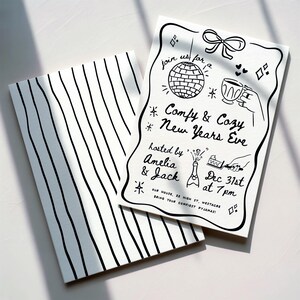 May include: Two white cards with black line art. One card has vertical stripes. The other card features a New Year's Eve party invitation with a disco ball, champagne, and the text "Comfy & Cozy New Years Eve".