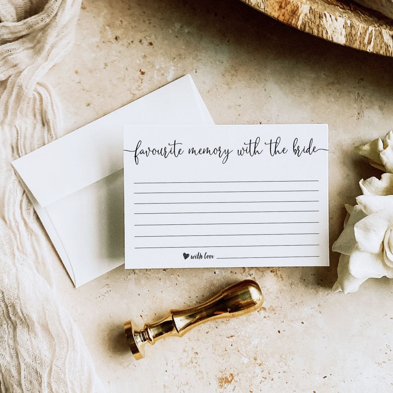 May include: White card with the text "favourite memory with the bride" in black cursive writing. The card has lines for writing and the text "with love" at the bottom.
