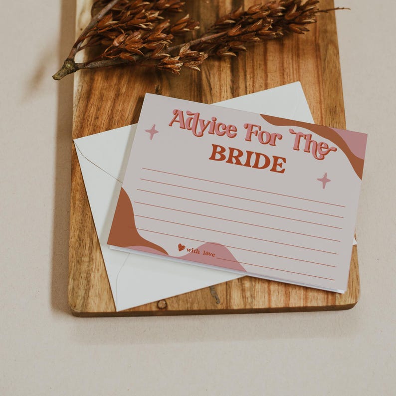 May include: A light pink advice card for the bride with the text "Advice For The Bride" in a retro font. The card has a white envelope and is decorated with brown and pink abstract shapes and star accents. The words "with love" are at the bottom.