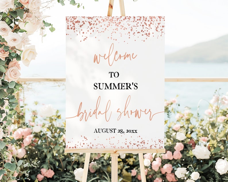 May include: White welcome sign with rose gold glitter and the text "Welcome to Summer's Bridal Shower August 28, 20XX".