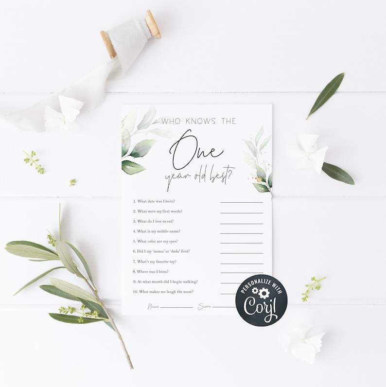 May include: A printable game card with a watercolor background of green leaves and white flowers. The text "Who knows the one year old best?" is at the top of the card. The card has a list of questions about a baby's first year, such as "What date was I born?" and "What were my first words?"