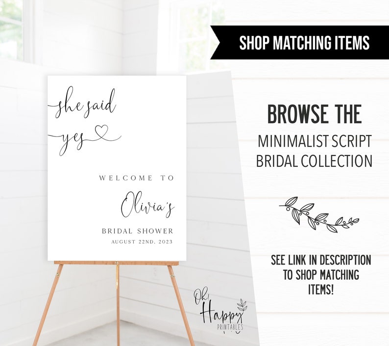 May include: A white printable sign with black text that reads "She said yes" with a heart symbol. The sign also says "Welcome to Olivia's Bridal Shower August 22nd, 2023".