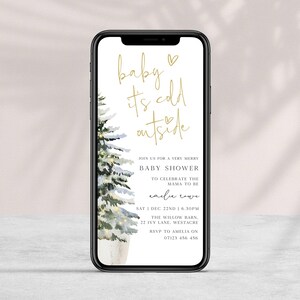 May include: A digital invitation for a baby shower with a watercolor illustration of a snowy pine tree. The text reads "baby it's cold outside" and includes details for the event, such as the date, time, location, and RSVP information.