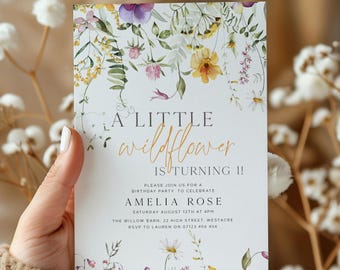 May include: A white invitation card with floral illustrations and the text "A LITTLE wildflower IS TURNING 11!" in a handwritten style. The card includes details for Amelia Rose's birthday party, including the date, time, and location.
