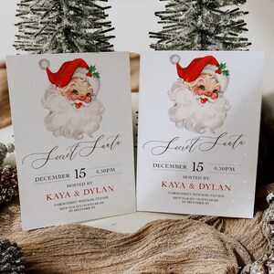 Pode incluir: Dois cart&otilde;es brancos com uma ilustra&ccedil;&atilde;o vintage do Papai Noel em cada um. Os cart&otilde;es s&atilde;o convites para uma festa de Secret Santa em 15 de dezembro &agrave;s 18h30. A festa &eacute; organizada por Kaya & Dylan na 25 High Street, Westacre, EX2 6GH. RSVP at&eacute; 1 de dezembro.