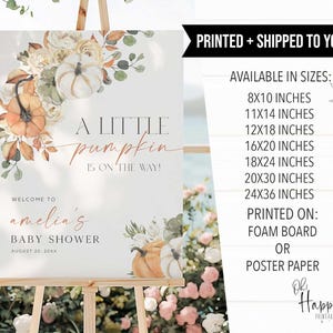 May include: A baby shower welcome sign on an easel. The sign features floral and pumpkin illustrations with the text "A Little Pumpkin is on the Way!" and "Welcome to amelia's Baby Shower". The sign is available in various sizes.