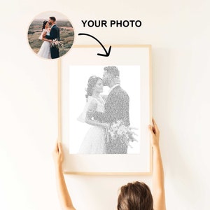 May include: A framed print featuring a couple in a tender embrace, composed of text. The image is in black and white, with the words "YOUR PHOTO" above it. The frame is light-colored.