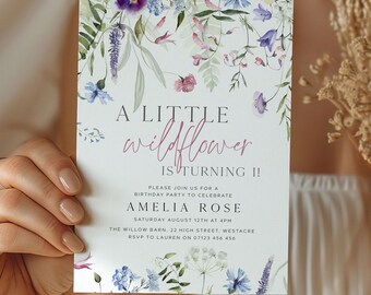 May include: A floral birthday party invitation with the text "A Little Wildflower is Turning 1!" in a whimsical font. The invitation features watercolor illustrations of purple, blue, and pink wildflowers and greenery.