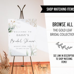 May include: A welcome sign for a bridal shower with a watercolor background featuring green leaves and gold accents. The text reads "Welcome to Daisy's Bridal Shower August 22nd, 2023 35 Days to Go!"