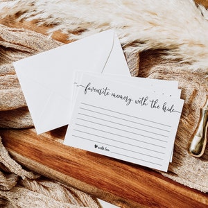 May include: White card with black text that reads "favourite memory with the bride" and a line for writing. The card has a small heart with the text "with love" at the bottom.