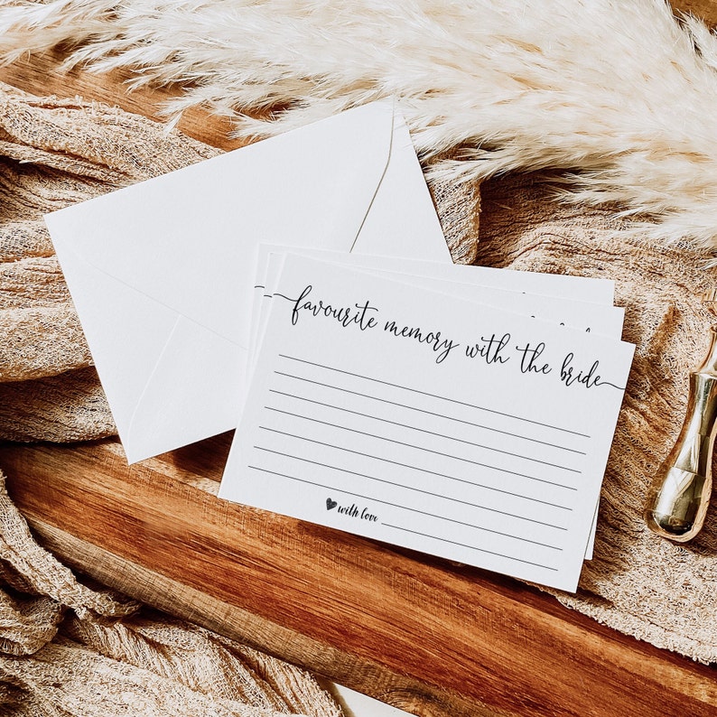 May include: White card with black text that reads "favourite memory with the bride" and a line for writing. The card has a small heart with the text "with love" at the bottom.