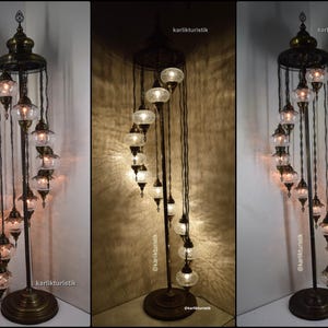 May include: A spiral floor lamp with a metal frame and multiple glass globes. The lamp has a traditional Turkish design and is lit with warm white bulbs.