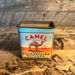 May include: Vintage Camel vulcanizing patches tin. The tin has a blue top and sides with a red and white Camel logo and a camel illustration. The text reads "10 Oblong Vulcanizing Patches for repairing tubeless tires and all types of tubes."