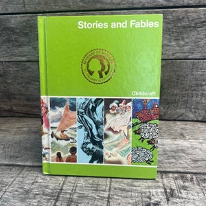 May include: A green hardcover book titled "Stories and Fables" with the Childcraft logo. The cover features a collage of colorful illustrations. A gold seal reads "50 Years of Service to Children Everywhere."