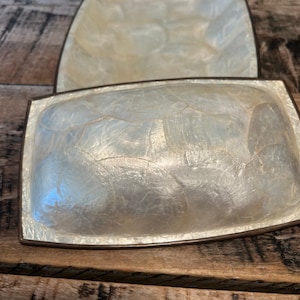 May include: A set of three ceramic mugs with a speckled, matte finish. The mugs are in shades of cream, light gray, and dark gray. Each mug has a simple, minimalist design, perfect for coffee or tea.