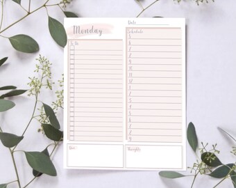 May include: A printable planner page with a pink watercolor background. The page is titled "Monday" and includes sections for "To Do", "Schedule", "Date", and "Thoughts".