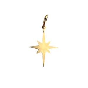 May include: A gold-colored star-shaped pendant with a pointed tip and eight points. The pendant has a loop at the top for attaching to a chain.