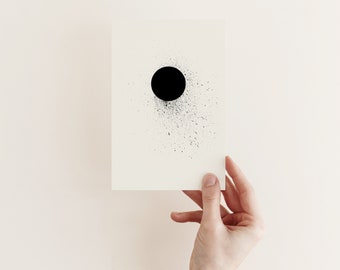 May include: A black circle with a splatter effect on a white background. The circle is centered on the page and is surrounded by a ring of black dots.