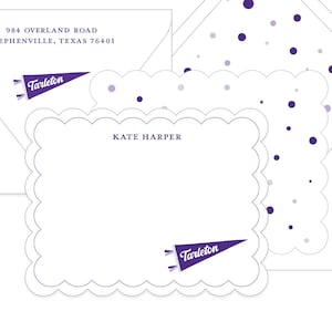 May include: A set of white stationery with a scalloped edge card, envelope, and lined envelope. The card and envelope feature a purple pennant with the word "Tarleton." The stationery set includes the text "Kate Harper" and the address "984 OVERLAND ROAD STEPHENVILLE, TEXAS 76401."