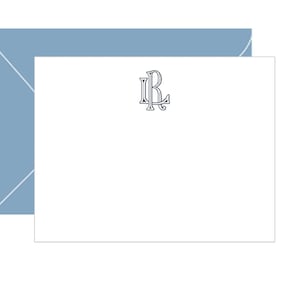 May include: A white A2 flat stationery card featuring a centered black monogram of the letters LR, accompanied by a matching dusty blue envelope. The text The Blue Coco A2 FLAT STATIONERY is printed at the top, and WWW.THEBLUECOCO.COM is at the bottom.