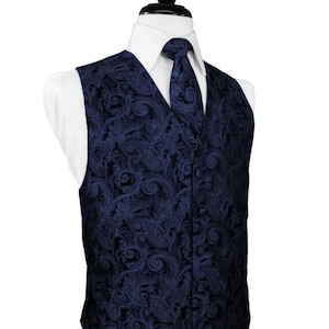 May include: A navy blue paisley patterned waistcoat with a matching tie. The waistcoat has a pointed bottom and a V-neck.