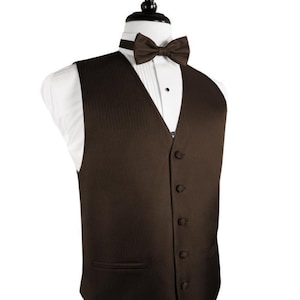 May include: A brown tuxedo vest with a satin finish and a herringbone pattern. The vest has six buttons and a pocket on the left side.