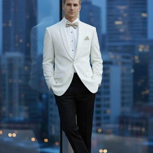 May include: A formal white tuxedo jacket with a shawl collar, paired with black trousers, a bow tie, and a pocket square. The outfit is completed with black dress shoes. The background features a cityscape.